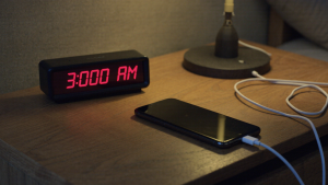Charging a phone at night to debunk common smartphone battery myths about overcharging.